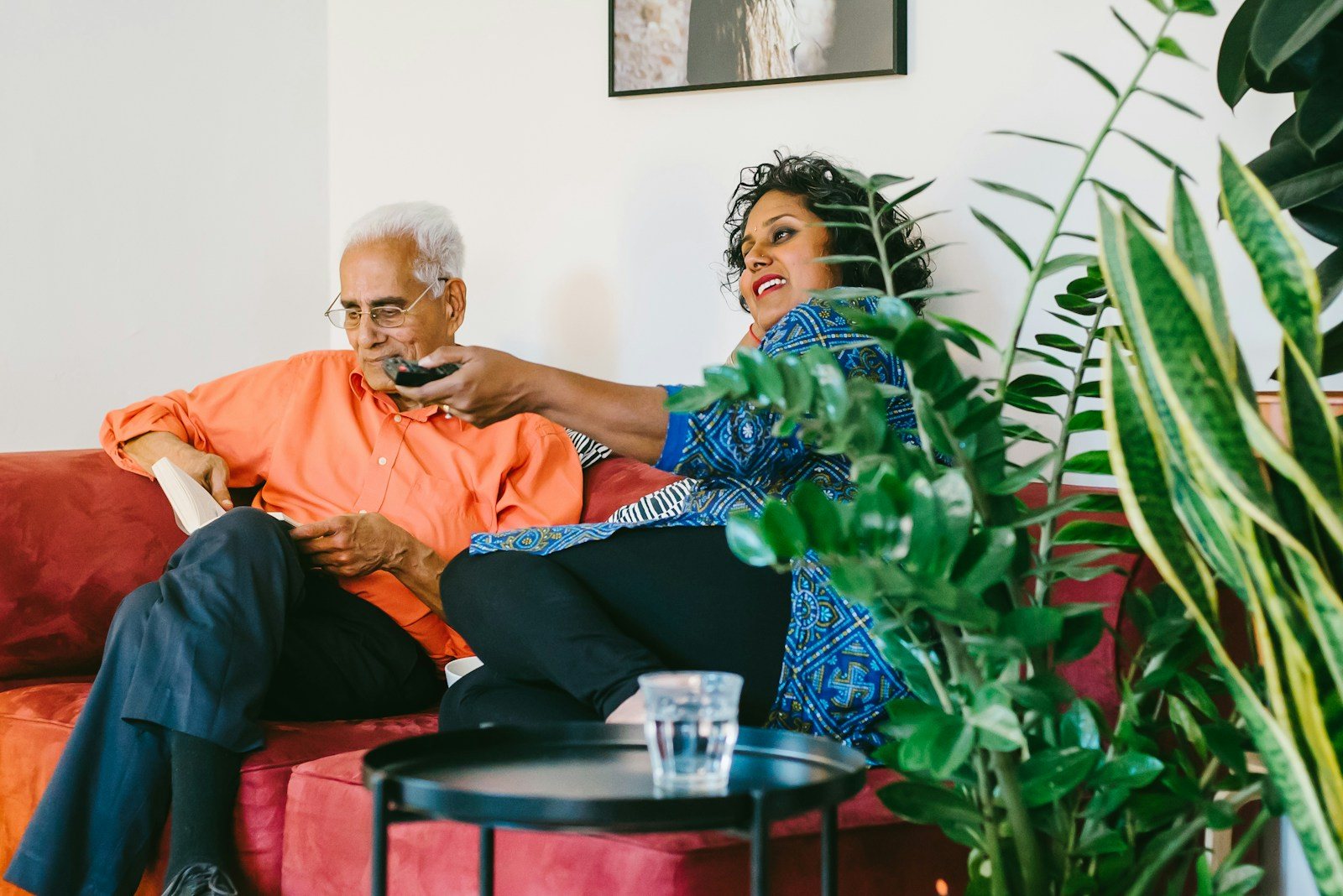An older South Asian couple sitting together at home